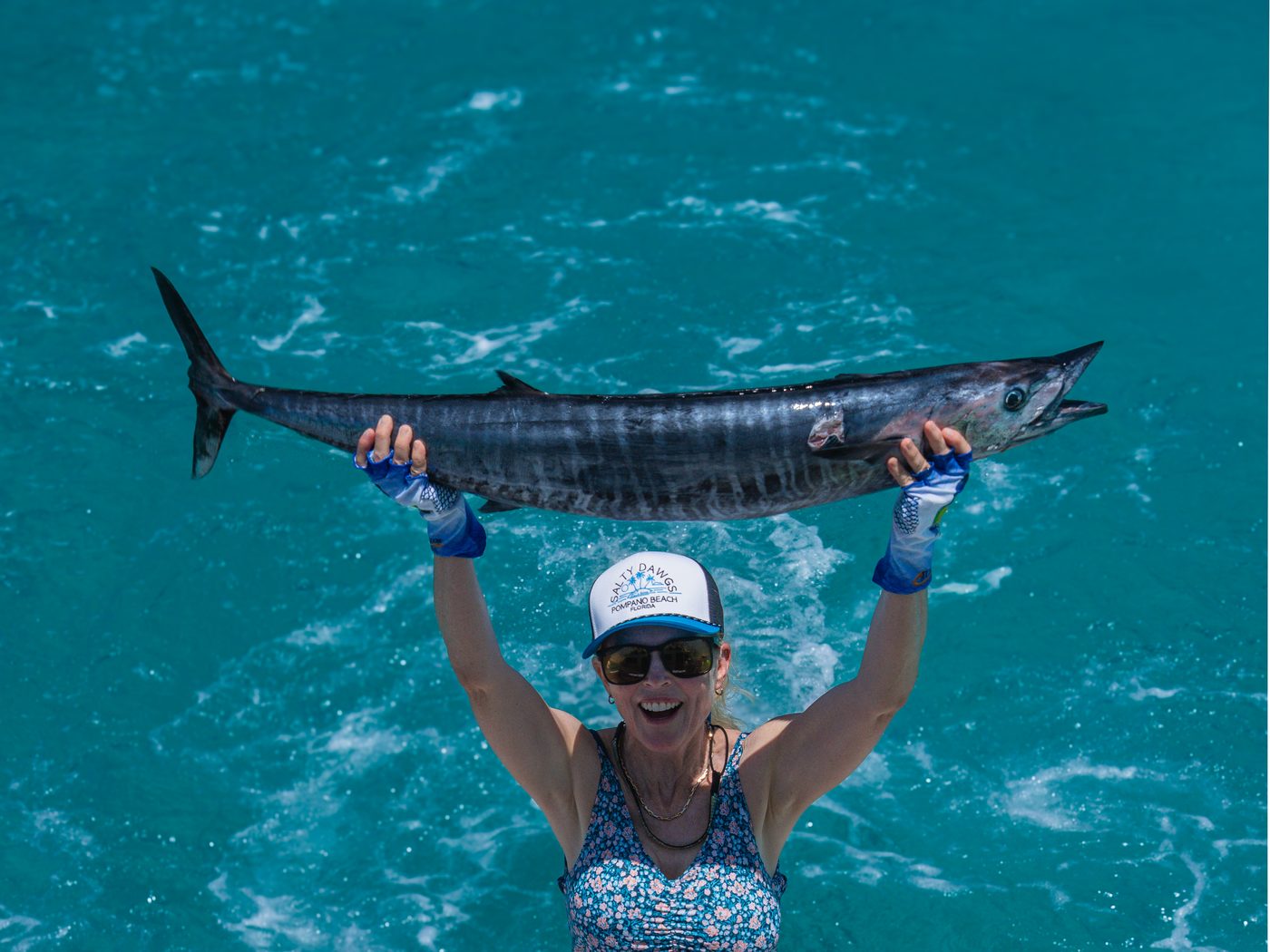 A wahoo lifted at the back of the boat